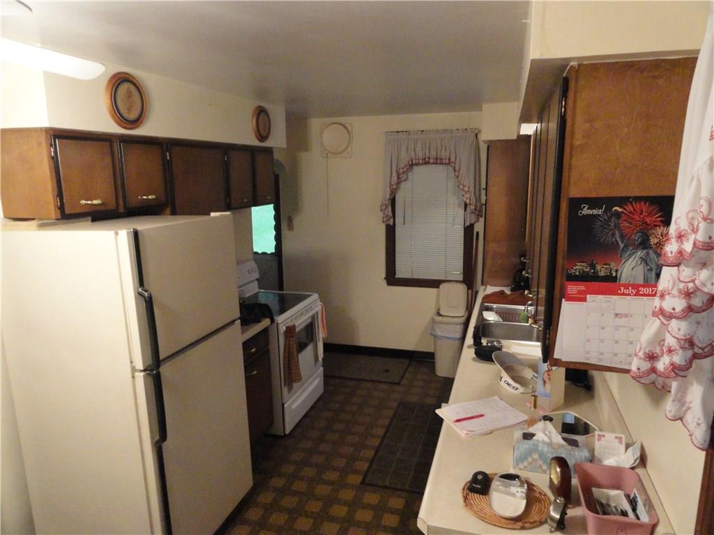 Large L shaped kitchen with appliances and built in deacon bench and china cupboard.