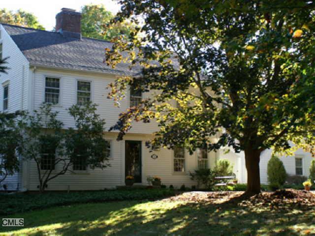 59 Standish Drive Ridgefield, CT 06877 - Photo 1 of 1 a front view of a house with a garden and tree