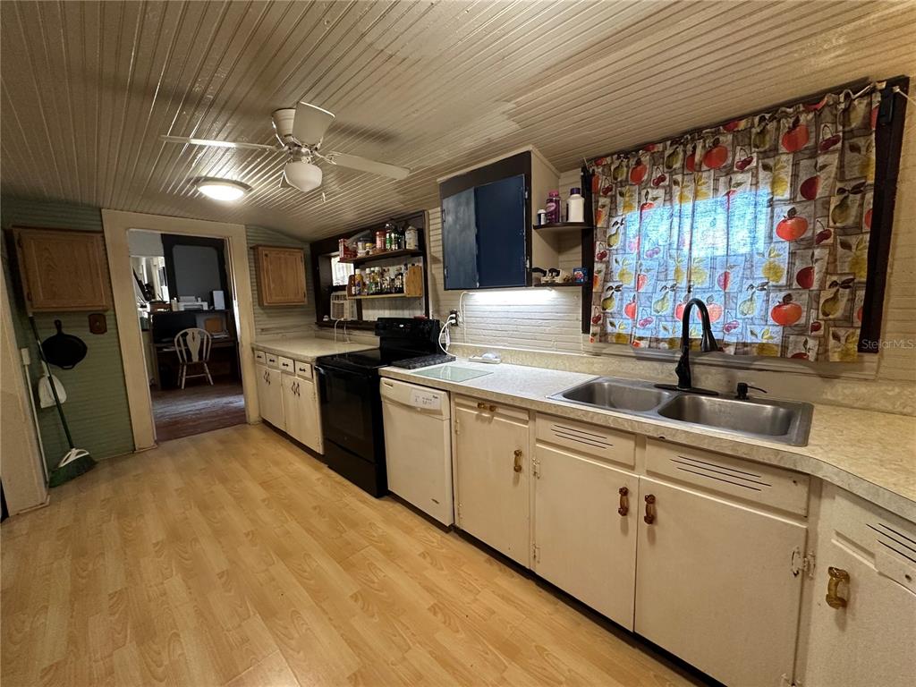 513 West Main Street Wauchula, FL 33873 - Photo 24 of 43 a kitchen with stainless steel appliances granite countertop a sink counter space cabinets and a large window