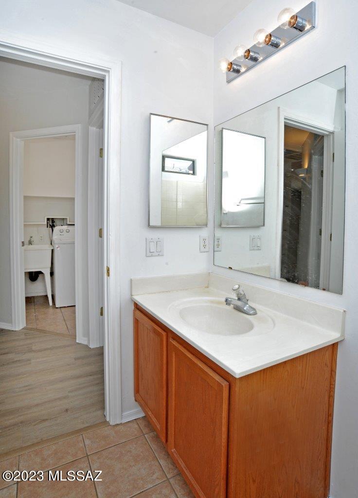 4543 South Valley Road Tucson, AZ 85714 - Photo 31 of 41 a bathroom with a sink and a mirror