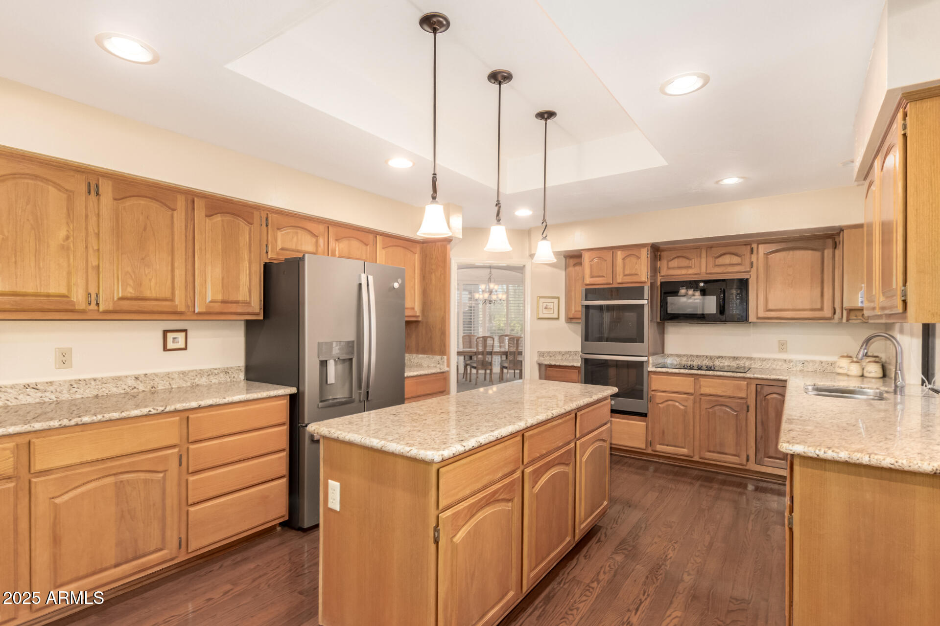 25628 Cordova Lane Rio Verde, AZ 85263 - Photo 10 of 35 a kitchen with stainless steel appliances granite countertop a refrigerator a sink dishwasher a oven and a dining table with wooden floor