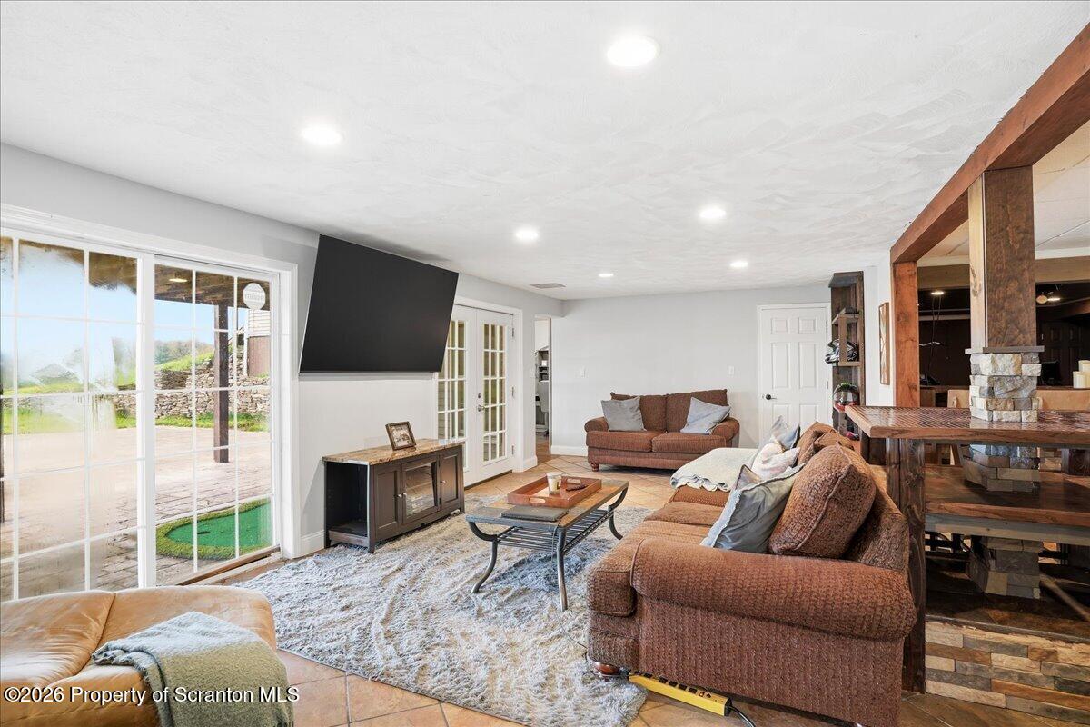 18 Bush Hill Road Great Bend, PA 18821 - Photo 56 of 125 a living room with furniture a flat screen tv and a large window
