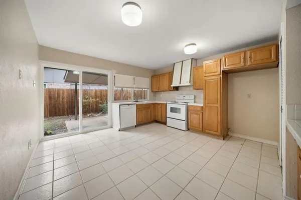 a kitchen with a stove a sink and a refrigerator