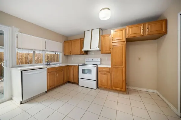 a kitchen that has a sink and a stove top oven