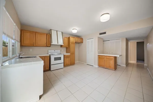a kitchen with stainless steel appliances a refrigerator and cabinets