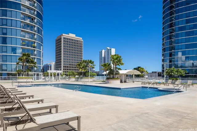 a view of a swimming pool and lounge chairs