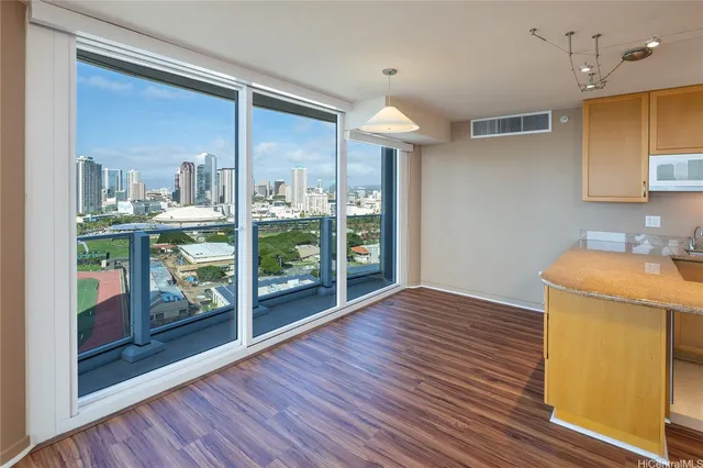 a view of a kitchen with furniture and wooden floor