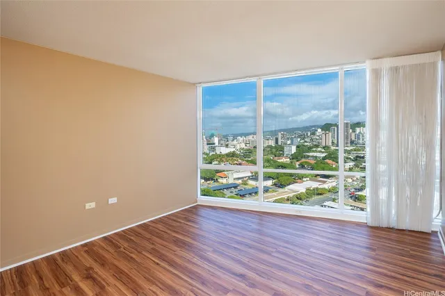 a room with wooden floor and a window