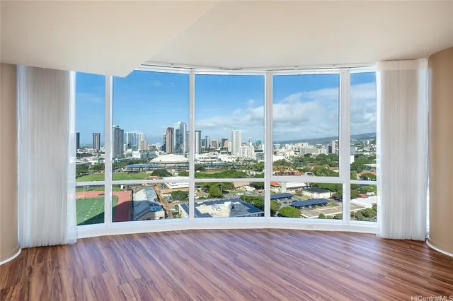 a view of a room with wooden floor and a window