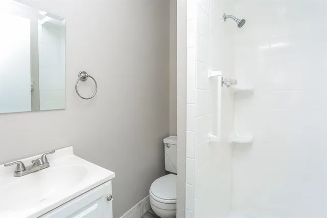 a bathroom with a toilet sink and vanity