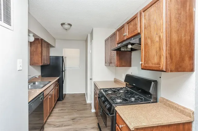 a kitchen with stainless steel appliances granite countertop a stove and a refrigerator