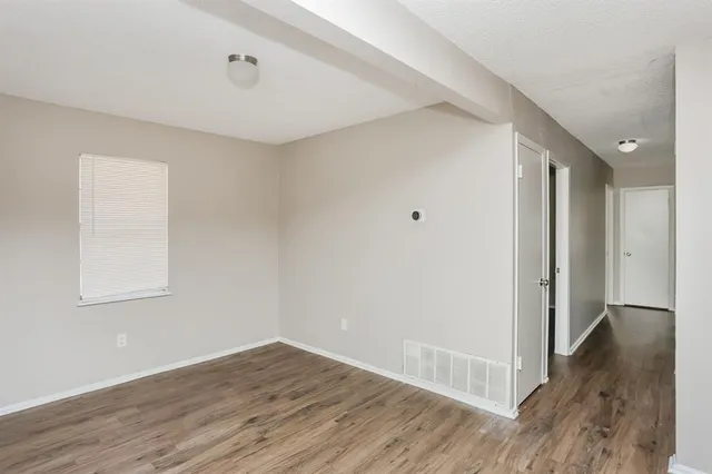 a view of a room with wooden floor