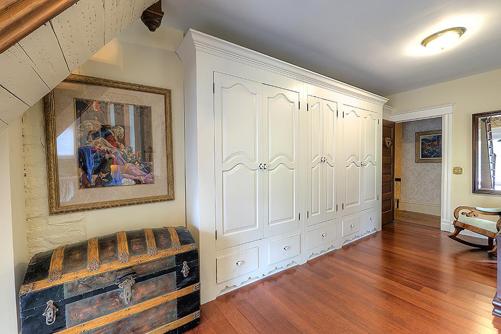 8395 Spring Brook Road Rockford, IL 61114 - Photo 13 of 24 a view of a hallway with wooden floor and cabinet