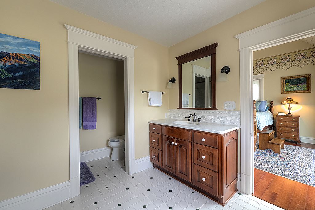 8395 Spring Brook Road Rockford, IL 61114 - Photo 16 of 24 a spacious bathroom with a double vanity sink a toilet and a mirror