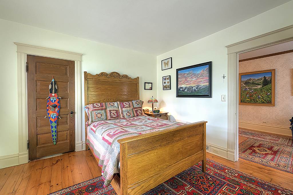 8395 Spring Brook Road Rockford, IL 61114 - Photo 9 of 24 a bedroom with a bed and wooden floor