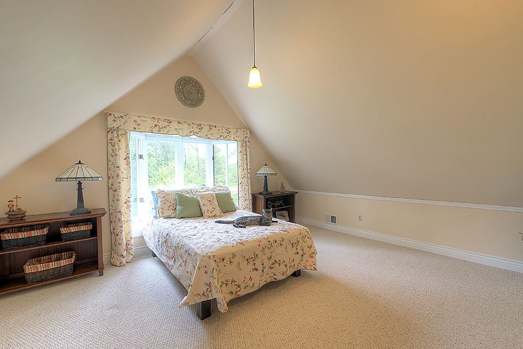 8395 Spring Brook Road Rockford, IL 61114 - Photo 10 of 24 a bedroom with a bed and a window