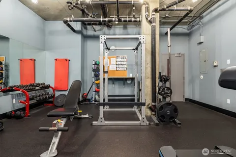 a room with gym equipment and a mirror
