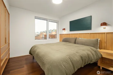 a bed sitting in a bedroom next to a window