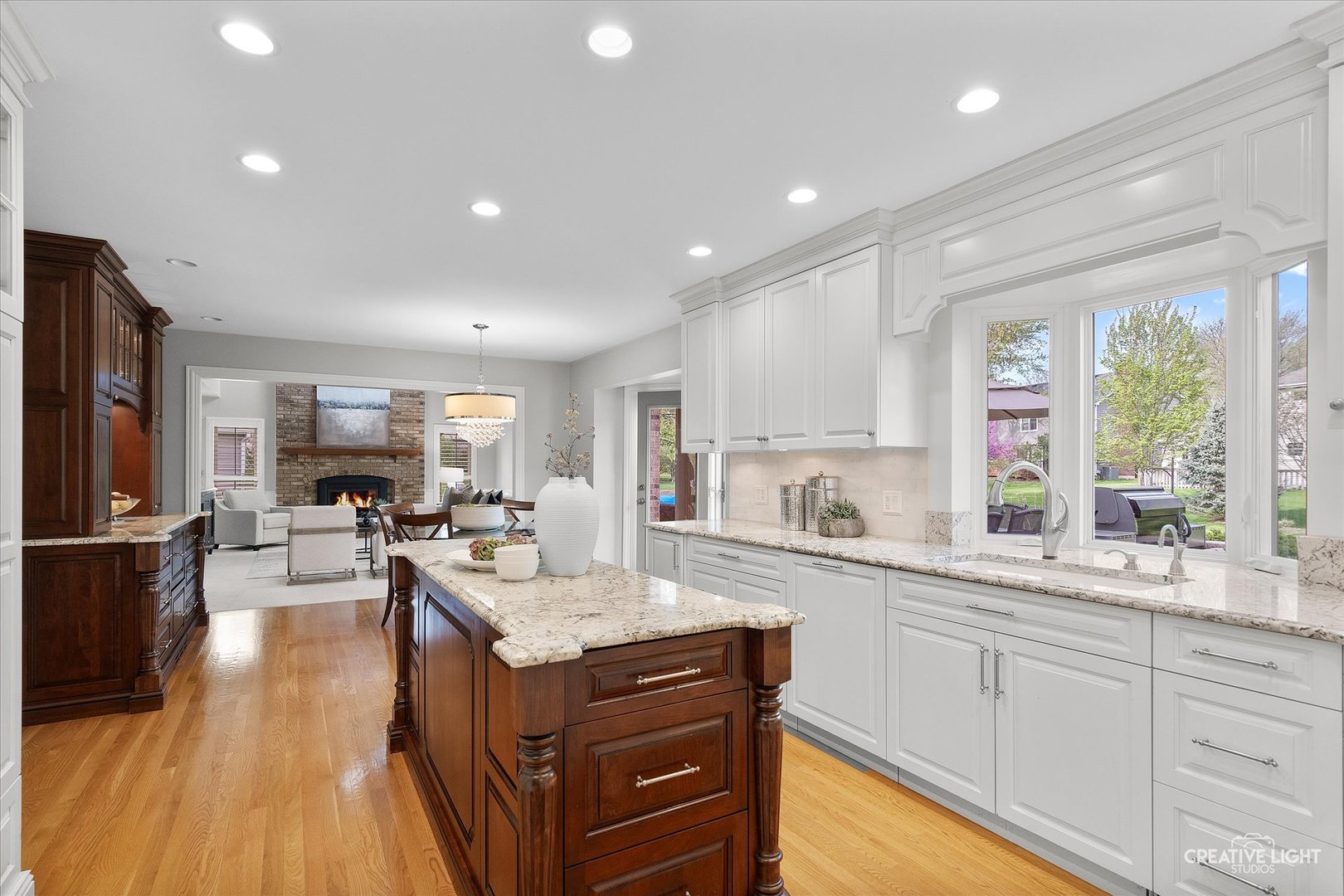 1454 Rill Court Naperville, IL 60565 - Photo 15 of 58 a kitchen with sink cabinets and wooden floor