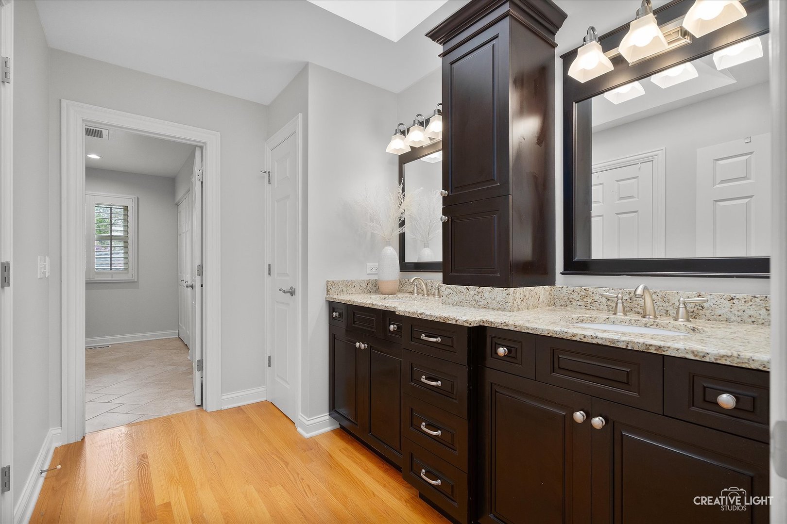 1454 Rill Court Naperville, IL 60565 - Photo 27 of 58 a spacious bathroom with a double vanity sink and a mirror