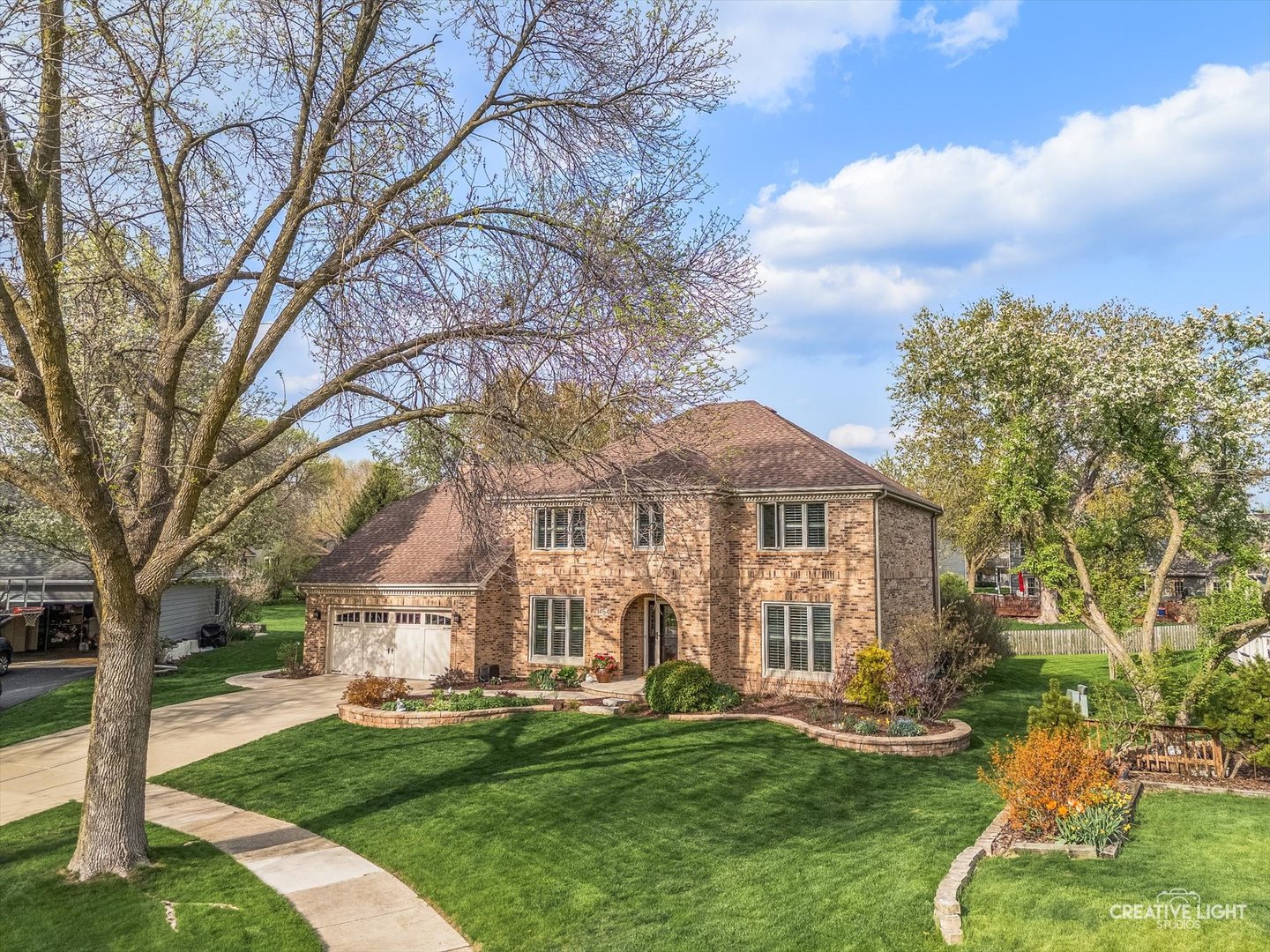 1454 Rill Court Naperville, IL 60565 - Photo 3 of 58 a front view of a house with a garden and trees