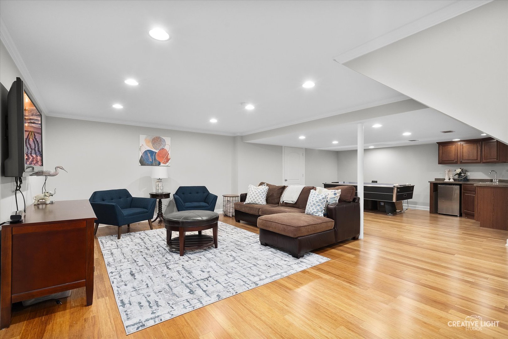 1454 Rill Court Naperville, IL 60565 - Photo 35 of 58 a living room with furniture and a flat screen tv