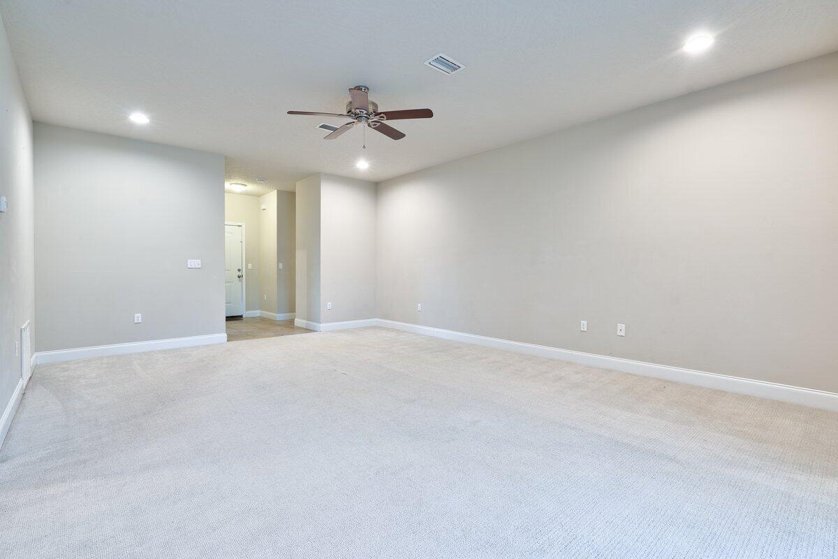 4614 Hermosa Road Crestview, FL 32539 - Photo 11 of 23 an empty room with chandelier fan and windows