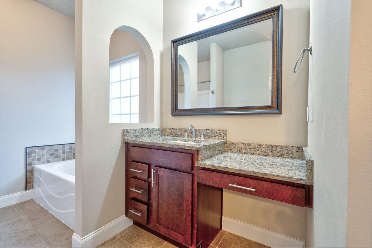 4614 Hermosa Road Crestview, FL 32539 - Photo 14 of 23 a bathroom with a granite countertop sink and a mirror