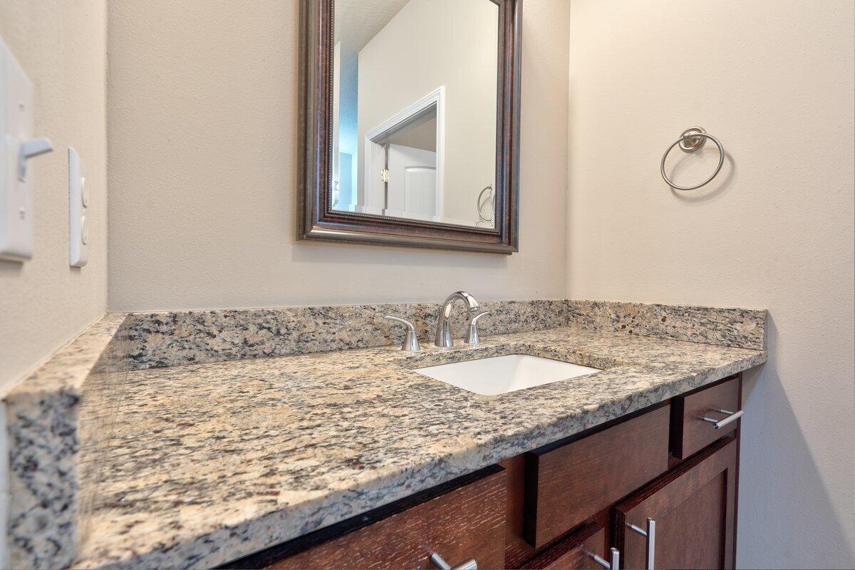 4614 Hermosa Road Crestview, FL 32539 - Photo 20 of 23 a bathroom with a granite countertop sink and a mirror