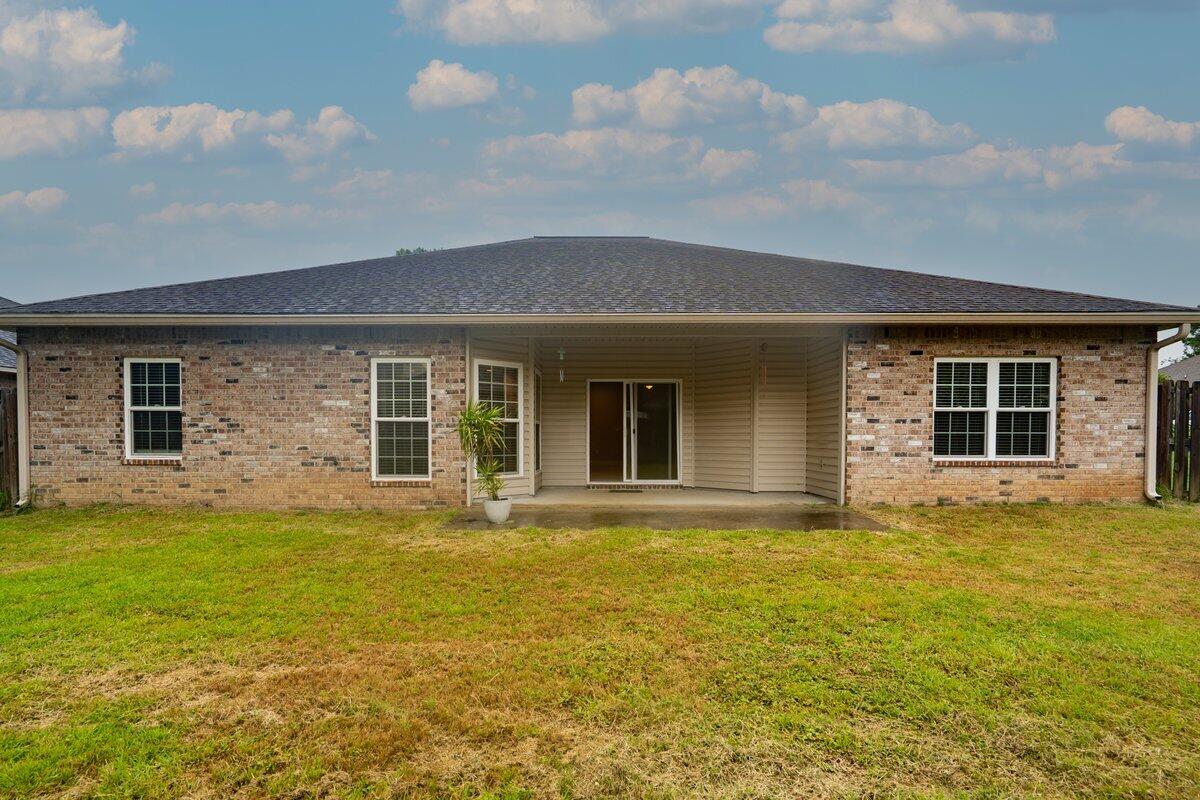 4614 Hermosa Road Crestview, FL 32539 - Photo 22 of 23 a front view of a house with a garden and yard