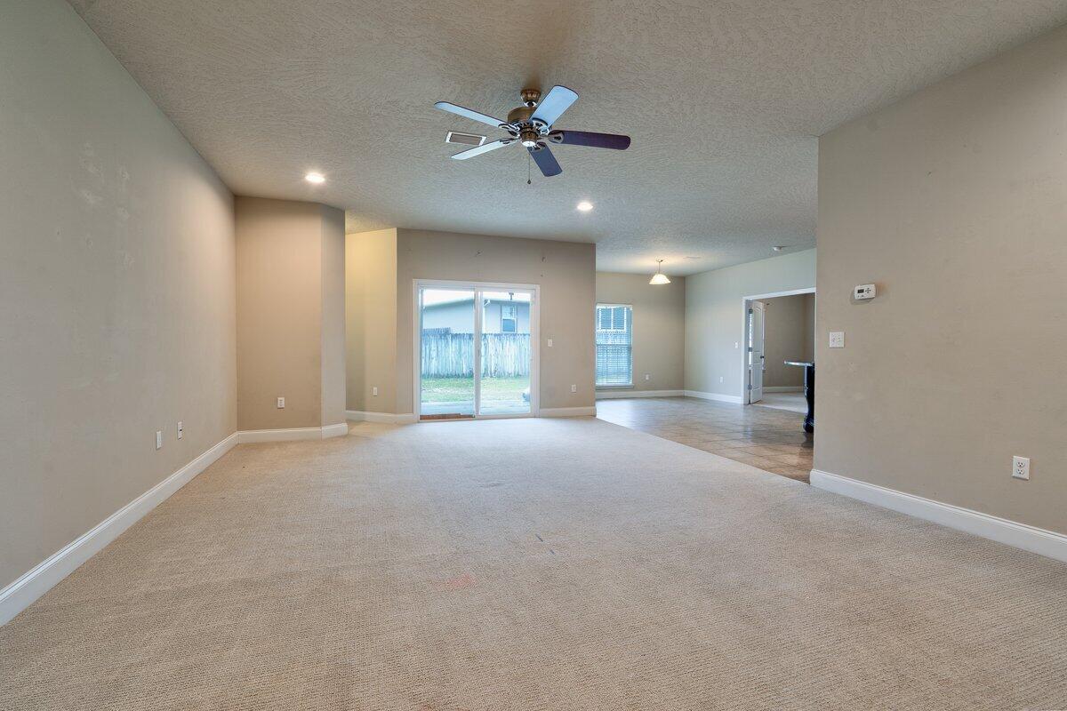4614 Hermosa Road Crestview, FL 32539 - Photo 3 of 23 a view of an empty room with a ceiling fan