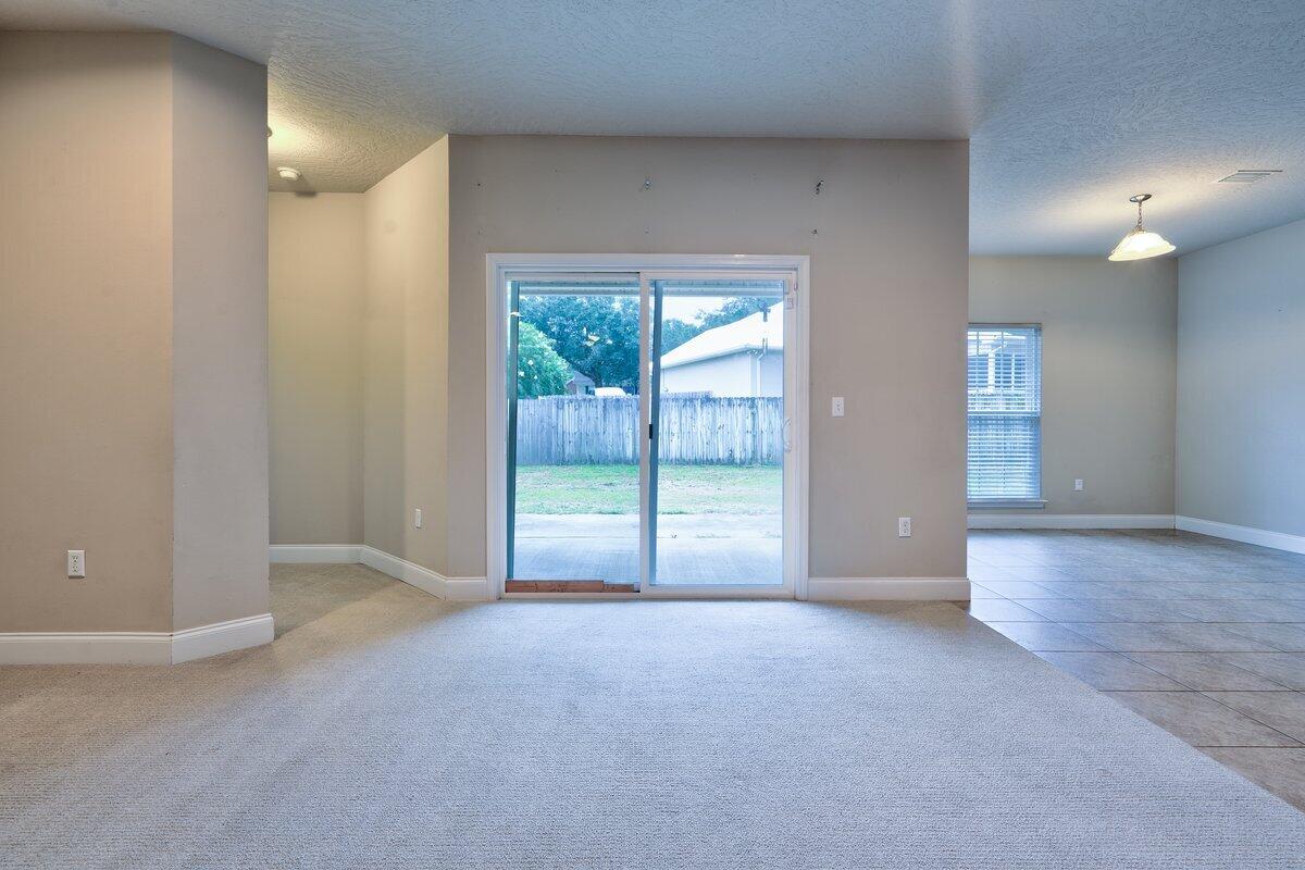 4614 Hermosa Road Crestview, FL 32539 - Photo 4 of 23 a view of an empty room with glass door