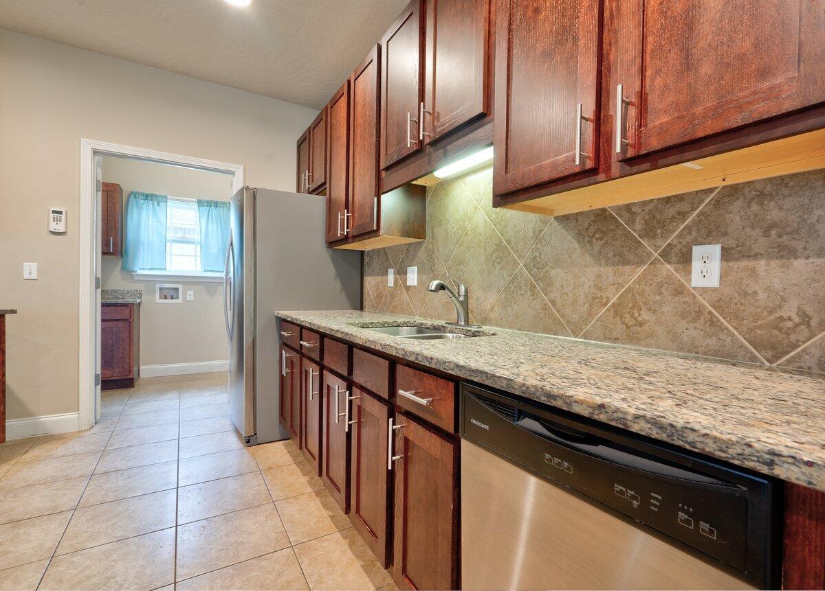 4614 Hermosa Road Crestview, FL 32539 - Photo 6 of 23 a kitchen with stainless steel appliances granite countertop a sink stove and cabinets