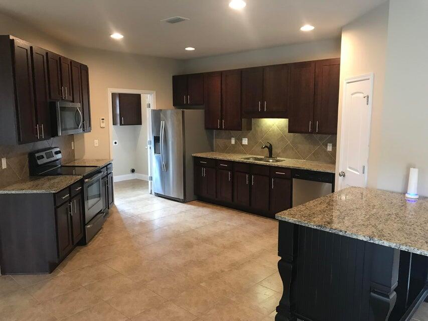 4614 Hermosa Road Crestview, FL 32539 - Photo 9 of 23 a kitchen with stainless steel appliances granite countertop a stove a refrigerator a sink and a oven