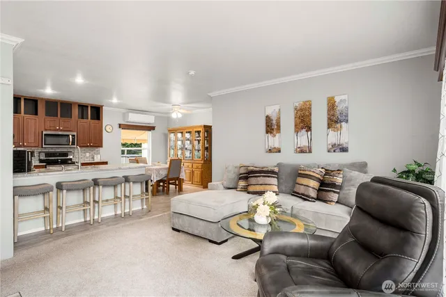 a living room with furniture and a kitchen