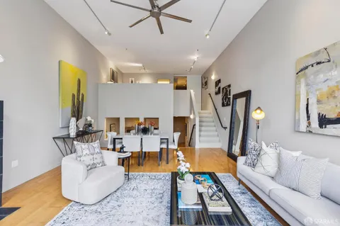a living room with furniture a rug and a chandelier