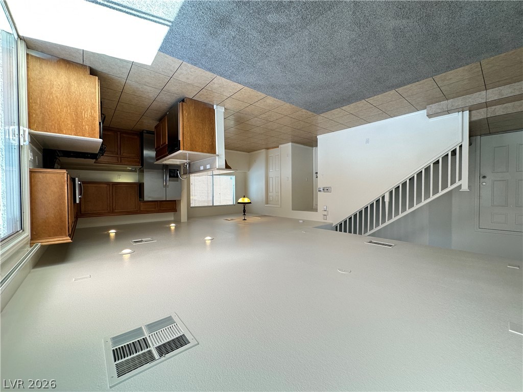 7305 Prussian Green Street Las Vegas, NV 89139 - Photo 22 of 23 An open floor plan seamlessly connects the kitchen to the living area and staircase.
