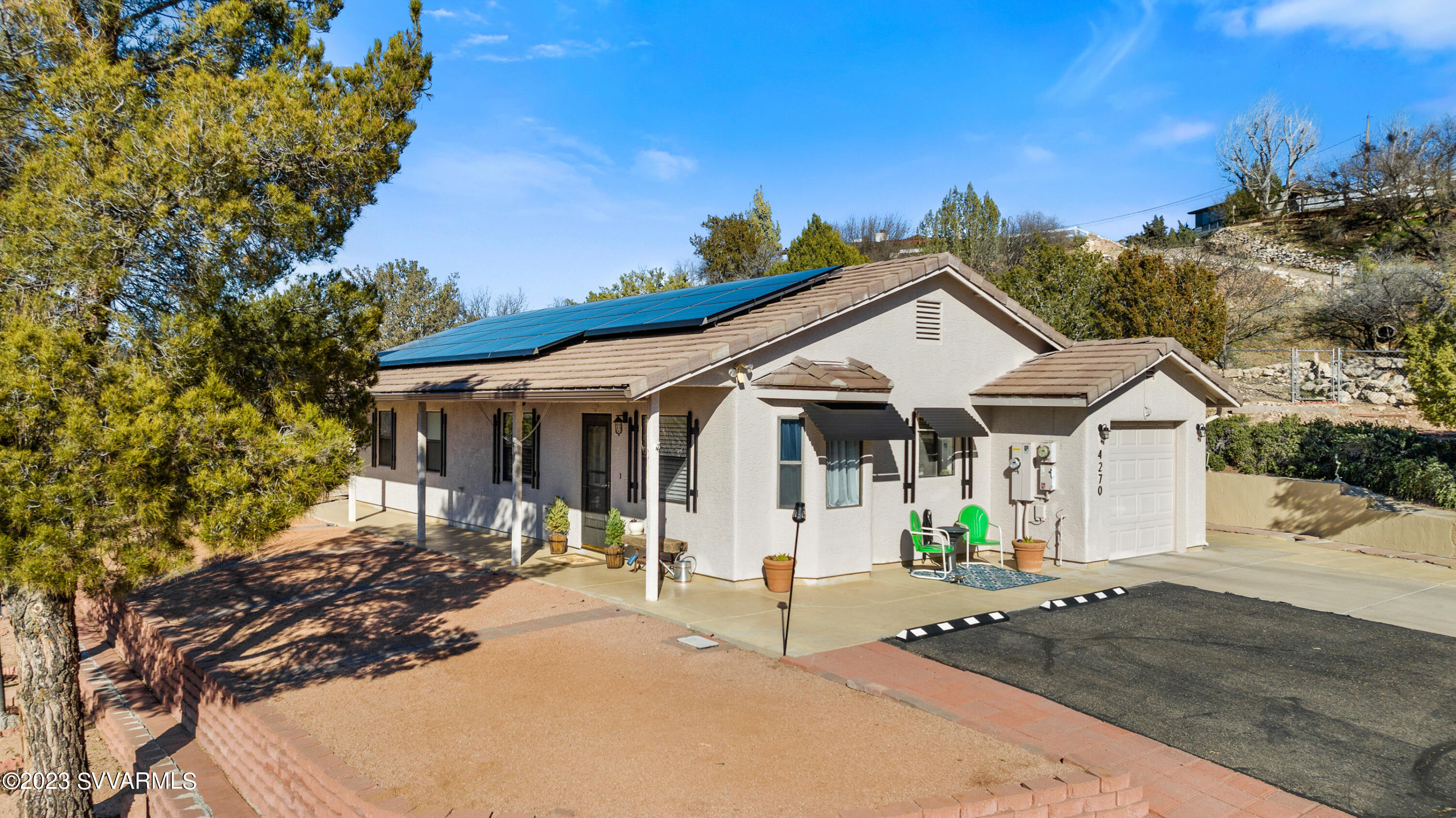 4270 Maya Way Rimrock, AZ 86335 - Photo 1 of 32 a view of a white house with a chairs in patio