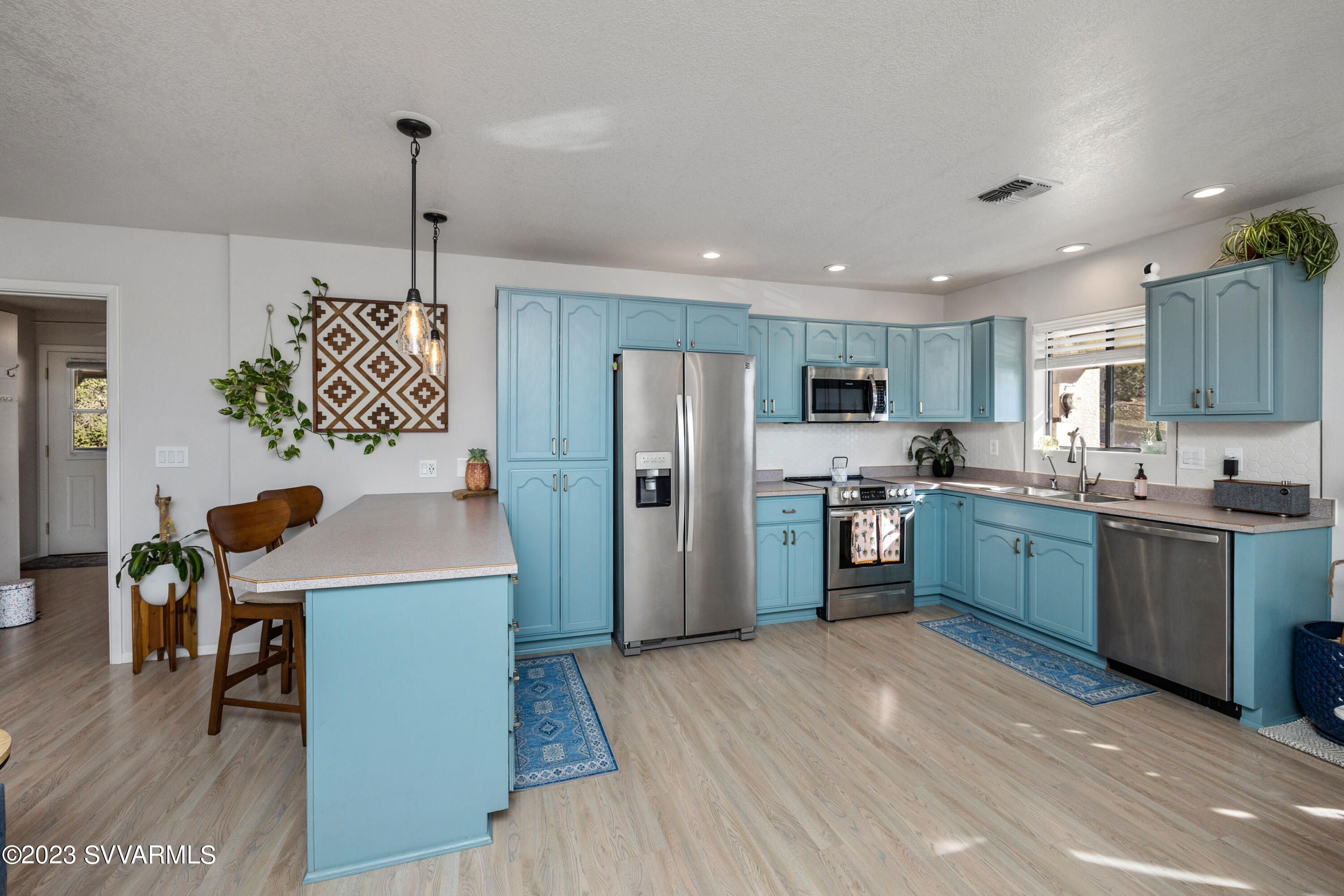 4270 Maya Way Rimrock, AZ 86335 - Photo 11 of 32 a kitchen with a refrigerator a sink dishwasher a oven with a dining table and chairs