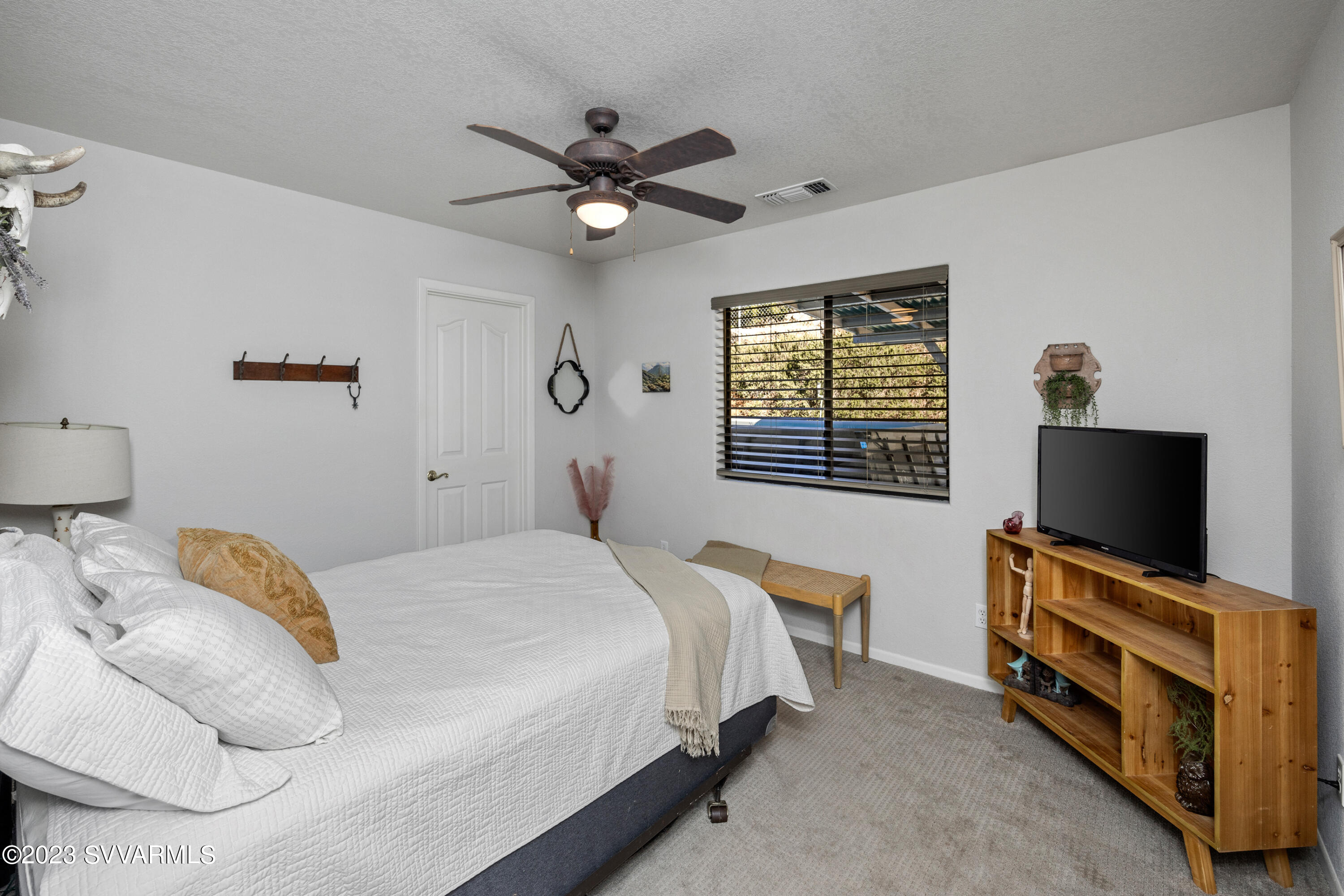 4270 Maya Way Rimrock, AZ 86335 - Photo 16 of 32 a bedroom with a bed and a flat screen tv