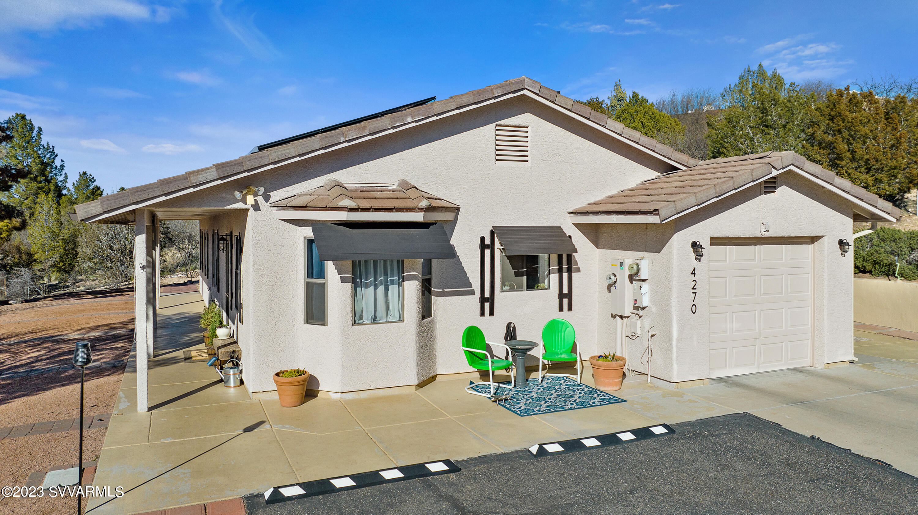 4270 Maya Way Rimrock, AZ 86335 - Photo 5 of 32 a view of a white house with potted plants