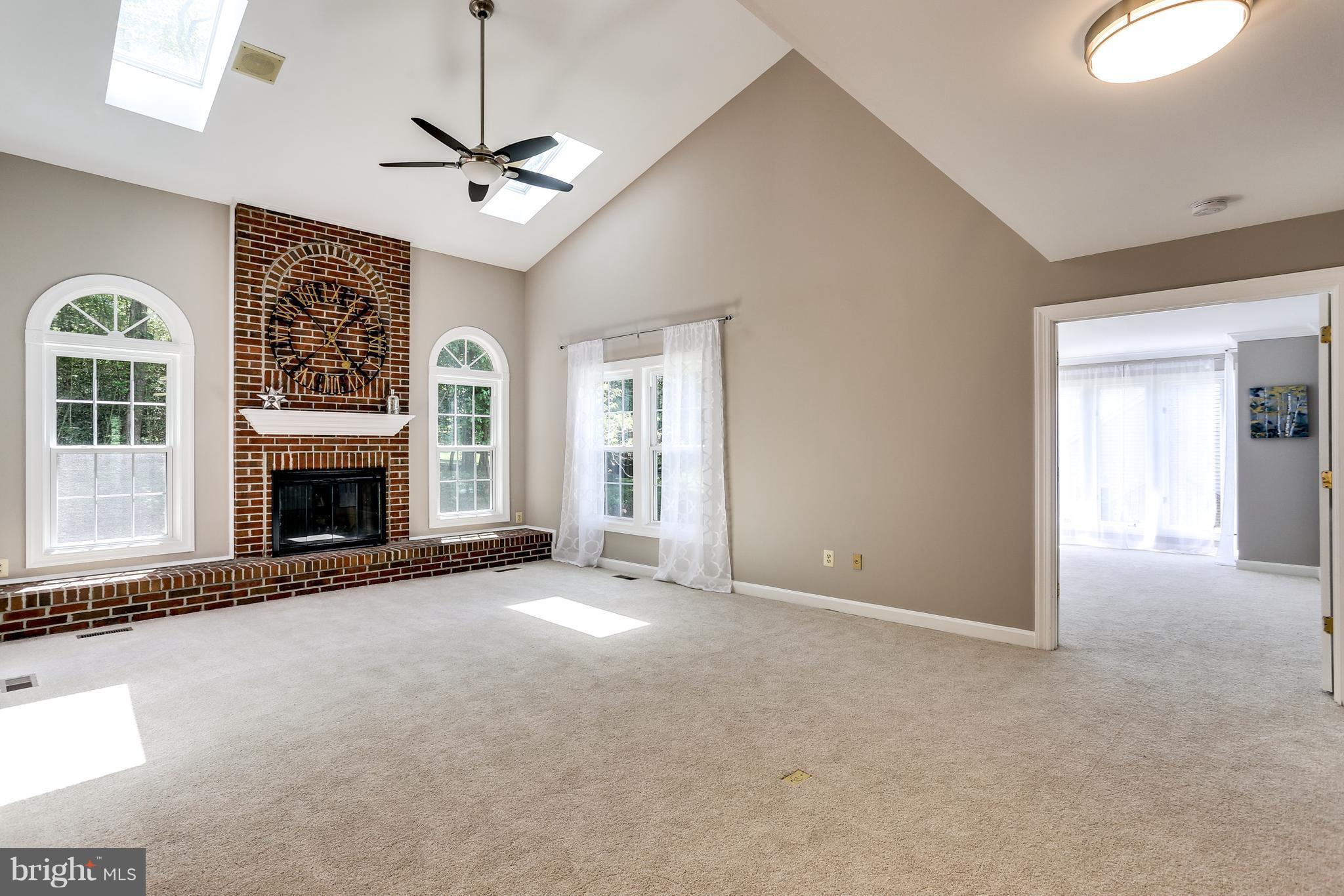 8394 Autumn Rust Road Ellicott City, MD 21043 - Photo 12 of 30 Large family room with fireplace and skylights.