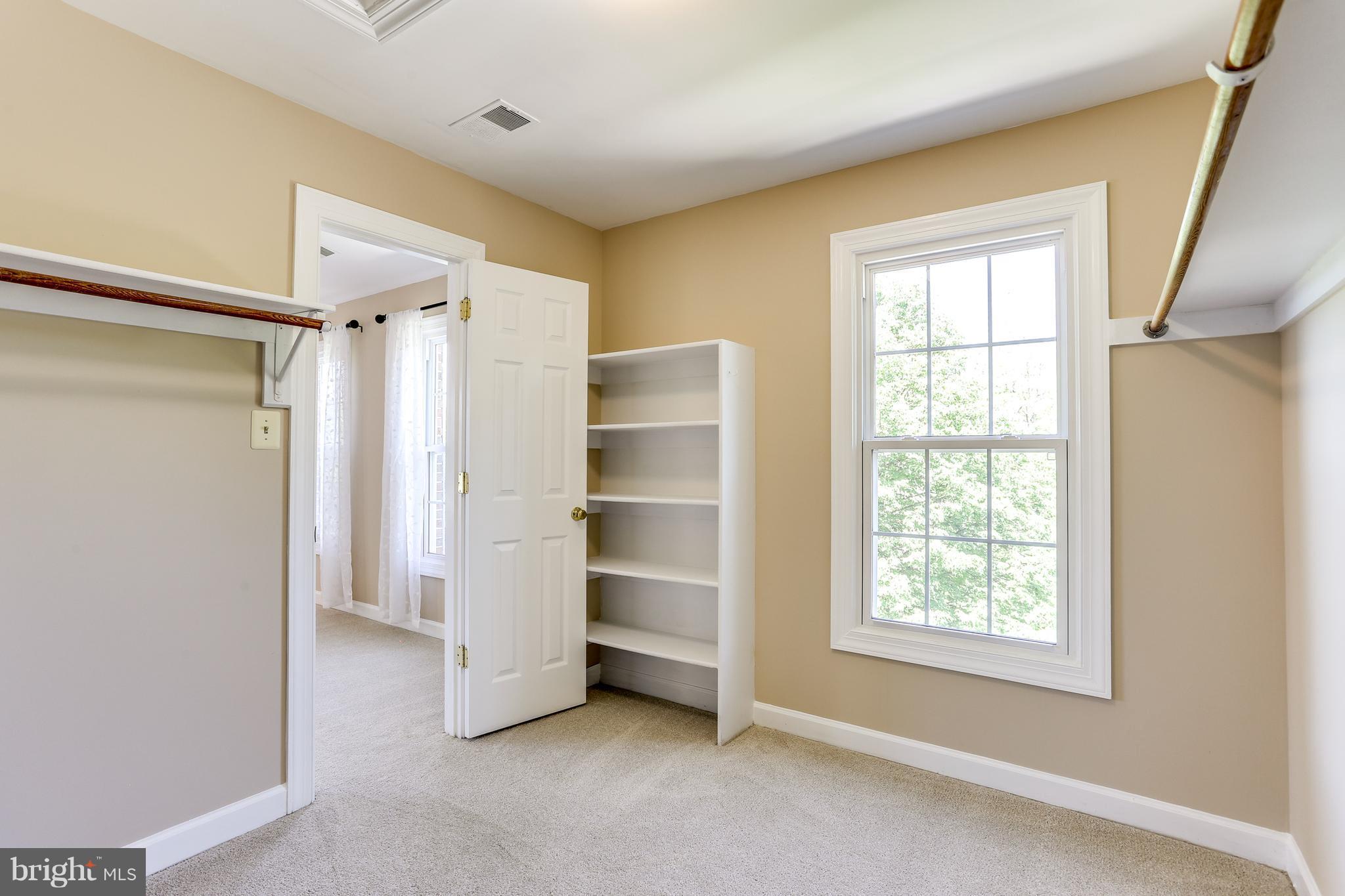 8394 Autumn Rust Road Ellicott City, MD 21043 - Photo 19 of 30 Walk in closet with window and shelives