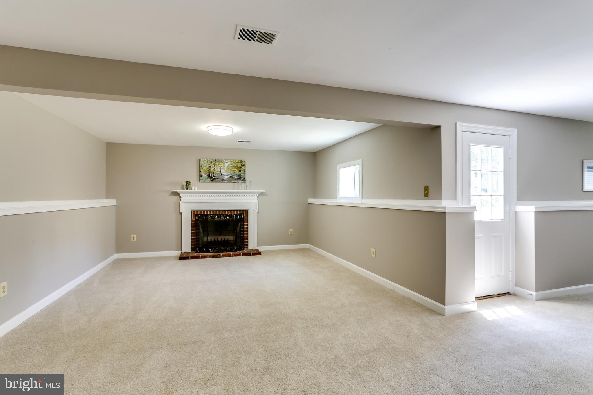8394 Autumn Rust Road Ellicott City, MD 21043 - Photo 25 of 30 Wood burning fireplace in basement recreation room