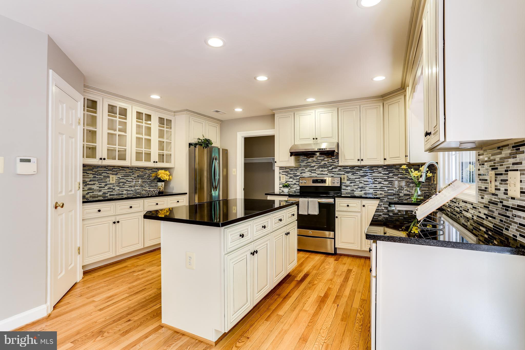 8394 Autumn Rust Road Ellicott City, MD 21043 - Photo 8 of 30 Top of the line cabinetry with pretty glass doors