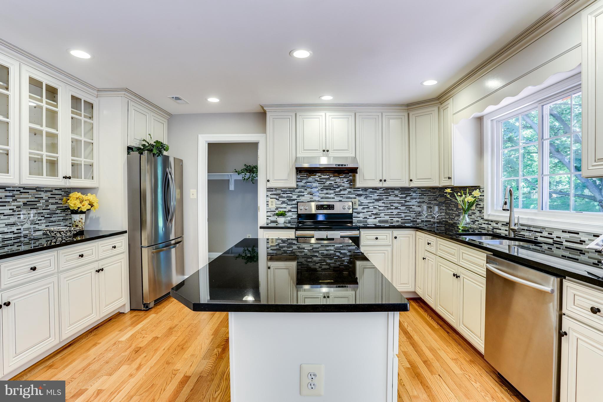 8394 Autumn Rust Road Ellicott City, MD 21043 - Photo 9 of 30 SS appliances, granite counters, modern backsplash
