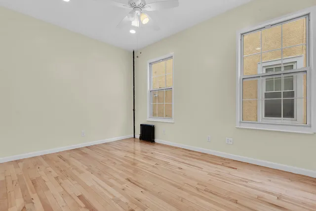 a view of hallway with wooden floor