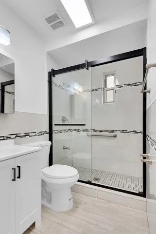 a view of a kitchen with wooden floor and cabinets