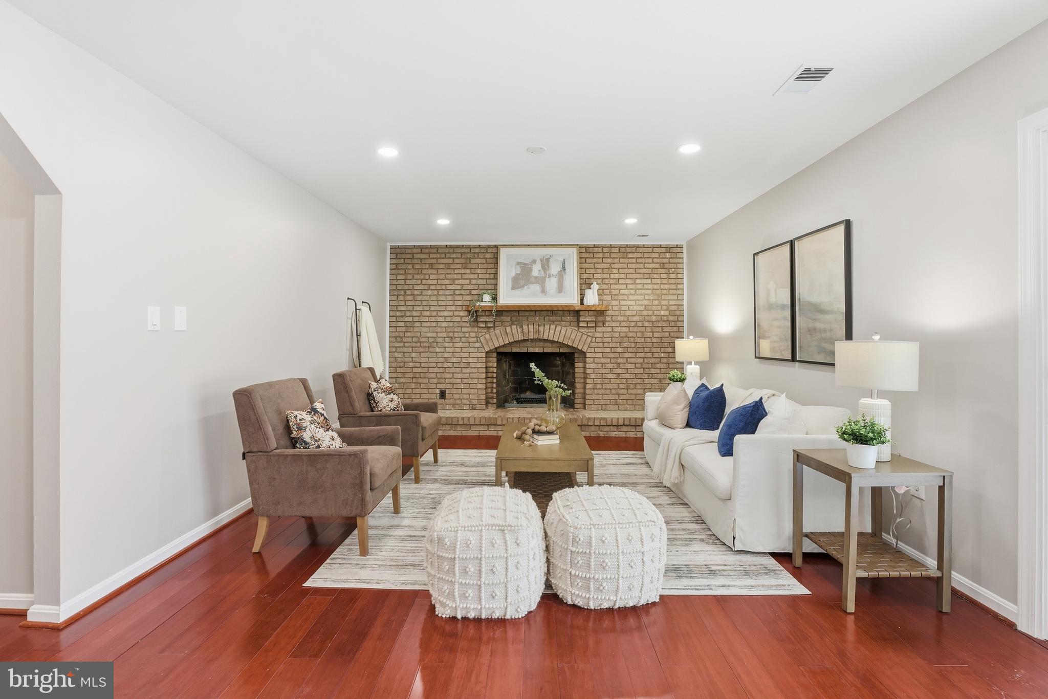 14740 Locustwood Lane Silver Spring, MD 20905 - Photo 15 of 46 a living room with fireplace furniture and a wooden floor