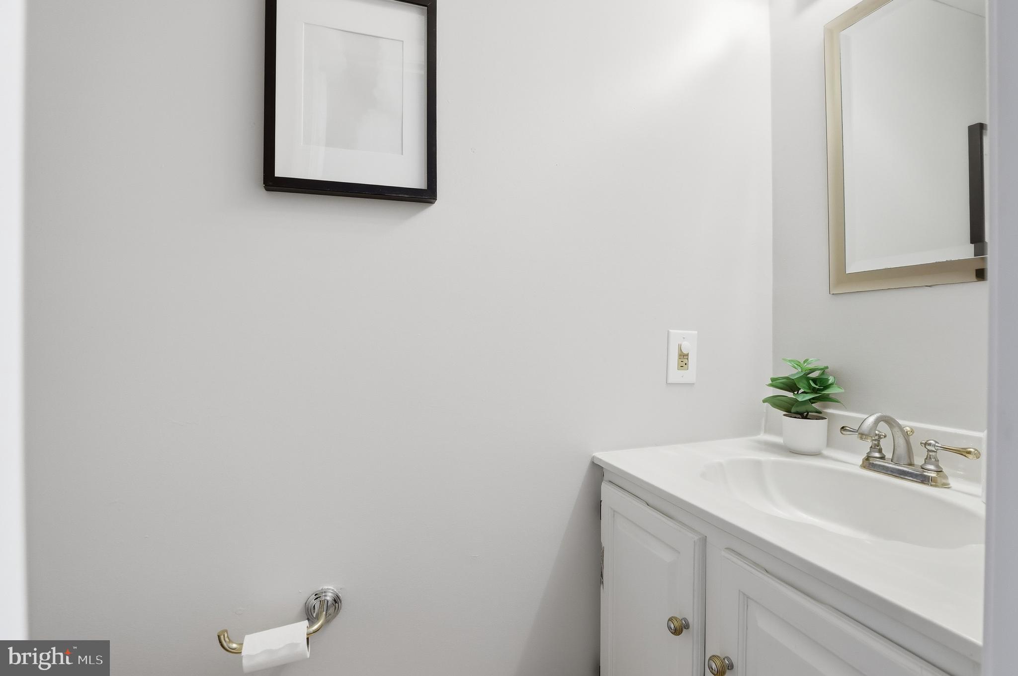 14740 Locustwood Lane Silver Spring, MD 20905 - Photo 17 of 46 a bathroom with a sink and a mirror
